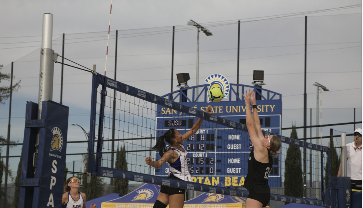 SJSU's Jaena Bell (left) goes up to the net against Broncos Teagan Wilson (right) at Spartan beach on Saturday.